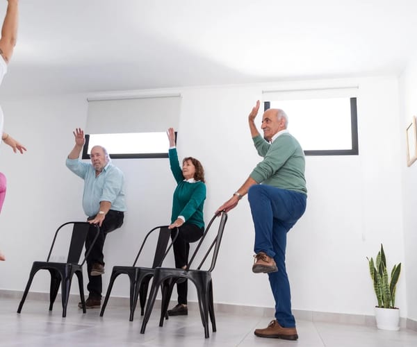 Seniors doing gentle yoga stretches together