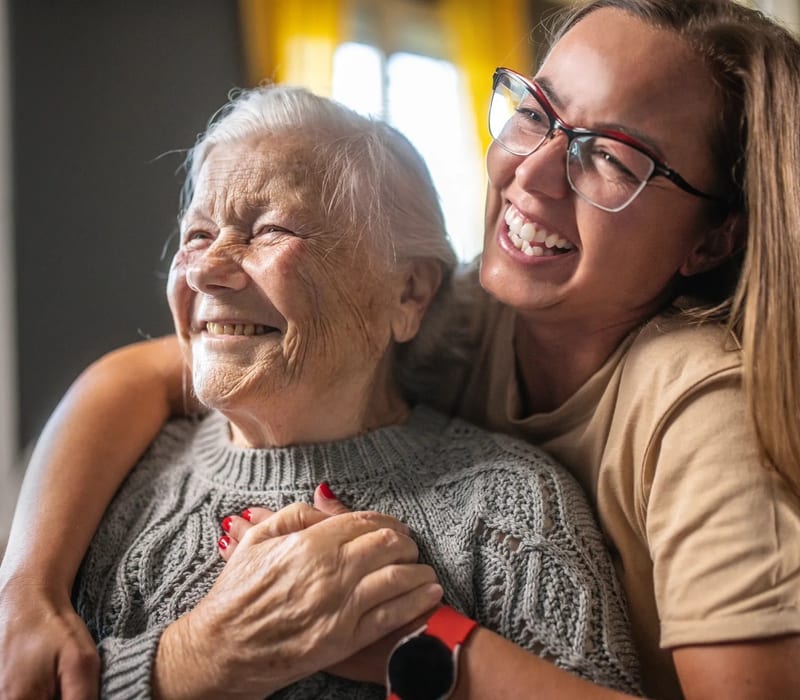 Family member visiting elderly mother at home